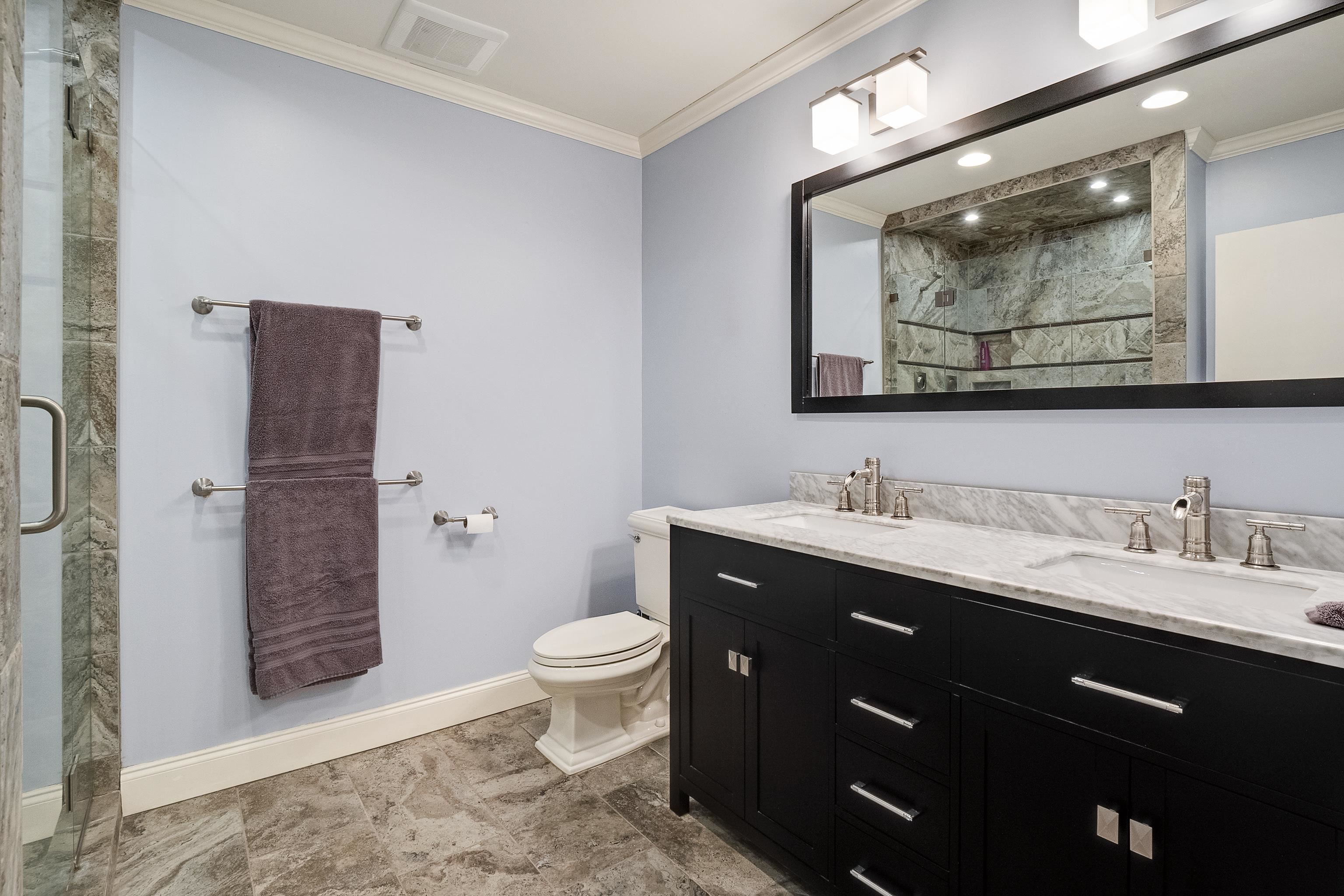 4939 Shady Grove Road Memphis, TN 38117 - Photo 20 of 36 a bathroom with a toilet sink double vanity and granite