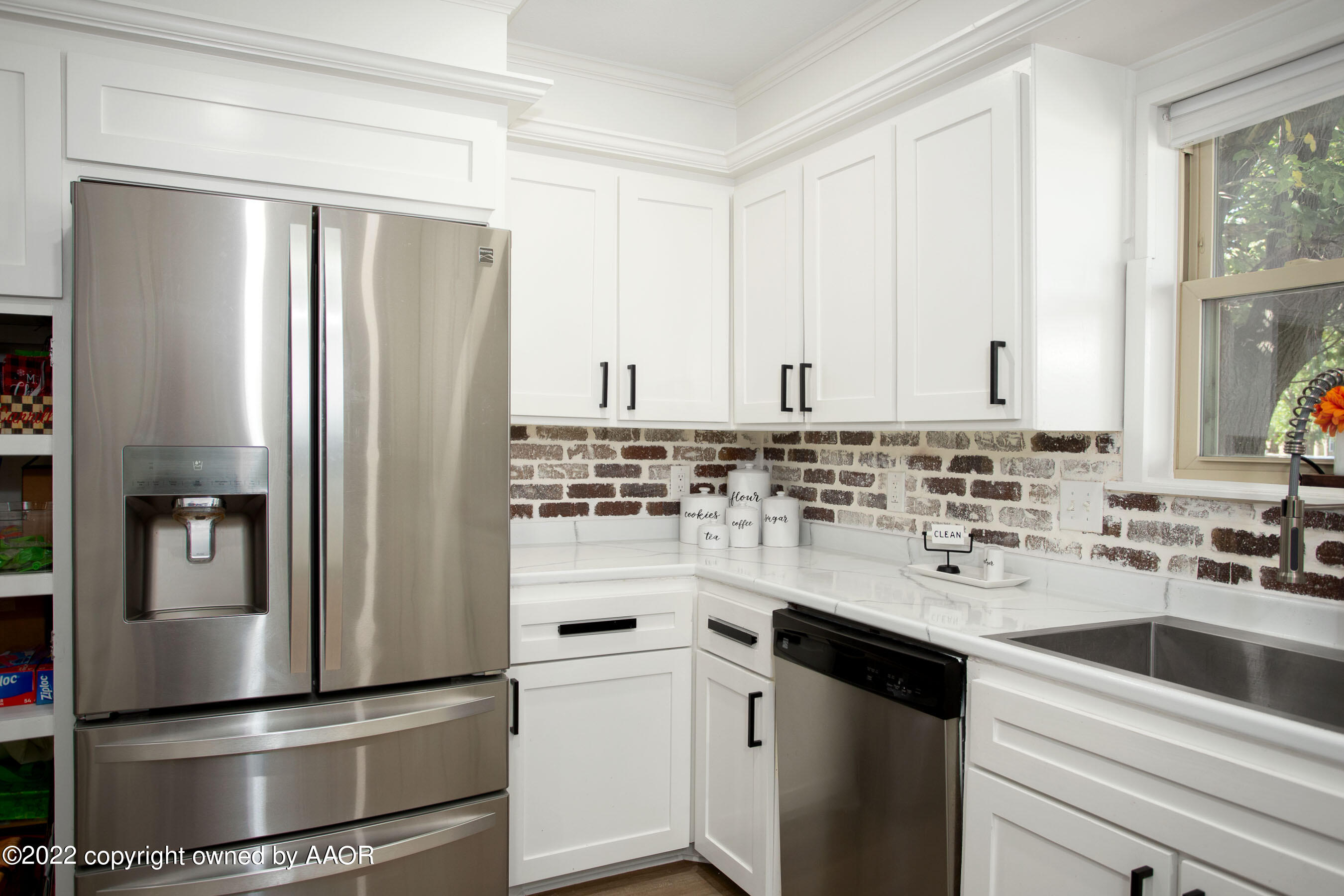7214 Jameson Road Amarillo, TX 79106 - Photo 13 of 31 a kitchen with a refrigerator and a sink