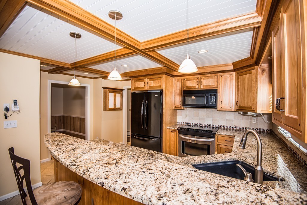 5 Twin Brooks Road Salisbury, MA 01952 - Photo 13 of 30 a kitchen with a sink a stove and refrigerator
