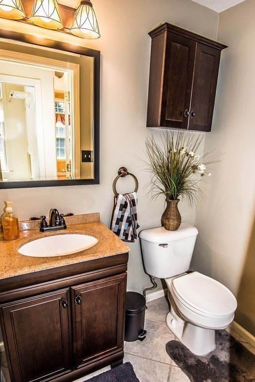 5 Twin Brooks Road Salisbury, MA 01952 - Photo 16 of 30 a bathroom with a toilet a sink and mirror