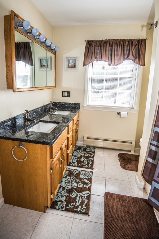 5 Twin Brooks Road Salisbury, MA 01952 - Photo 25 of 30 a kitchen with blue cabinets and a stove