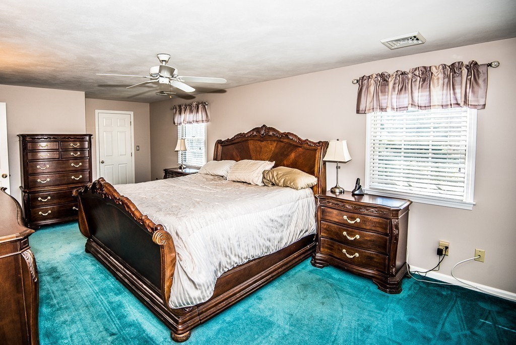 5 Twin Brooks Road Salisbury, MA 01952 - Photo 26 of 30 a spacious bedroom with a bed and a chandelier