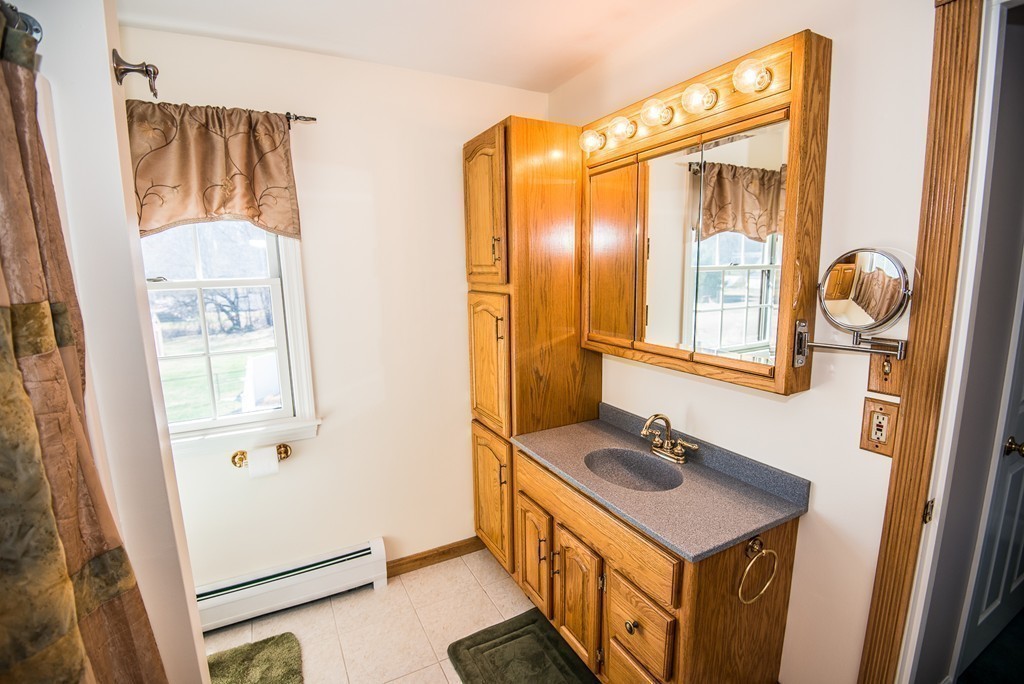 5 Twin Brooks Road Salisbury, MA 01952 - Photo 27 of 30 a bathroom with a sink a mirror and a shower