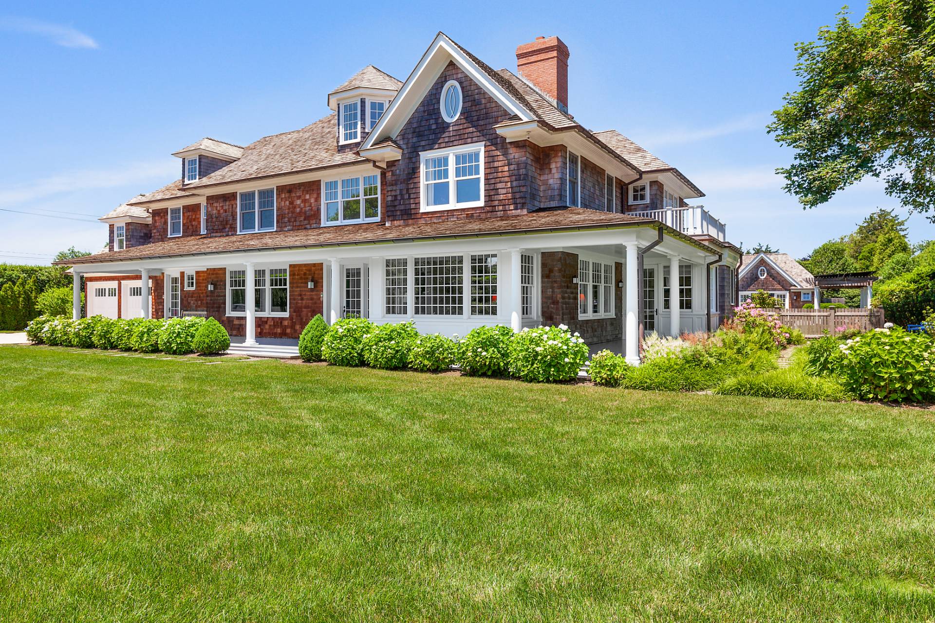 a front view of a house with a yard and trees