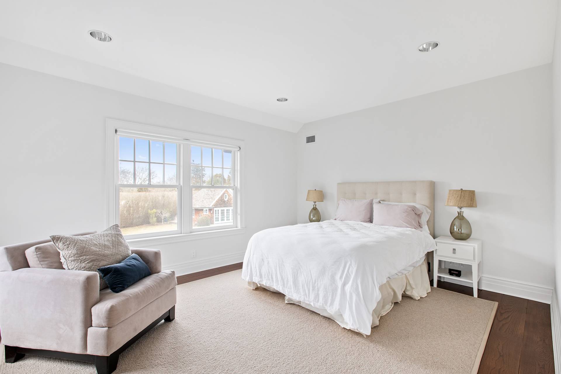 Undisclosed Address Water Mill, NY 11976 - Photo 17 of 26 a bedroom with a bed and a couch with window