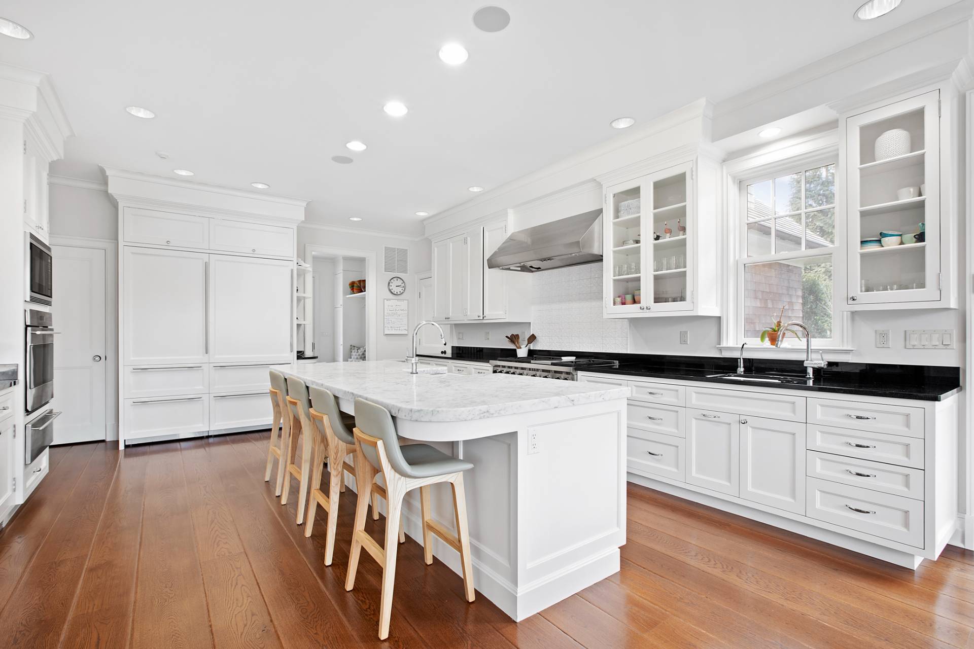 Undisclosed Address Water Mill, NY 11976 - Photo 4 of 26 a kitchen with stainless steel appliances granite countertop a white cabinets and wooden floor