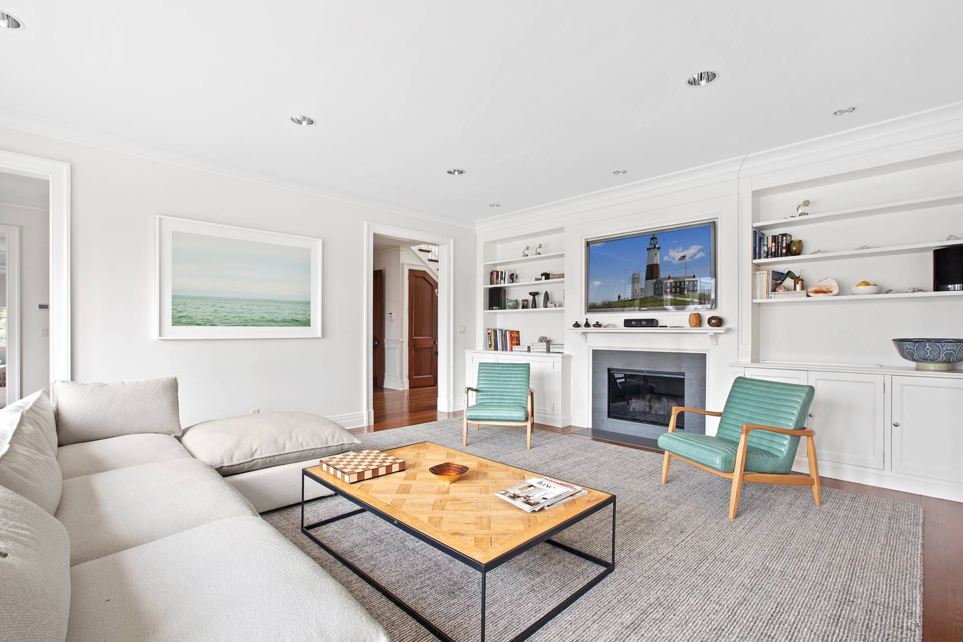 Undisclosed Address Water Mill, NY 11976 - Photo 6 of 26 a living room with furniture a flat screen tv and a fireplace