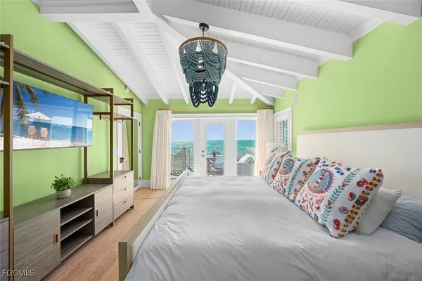 a spacious bedroom with a bed and a window