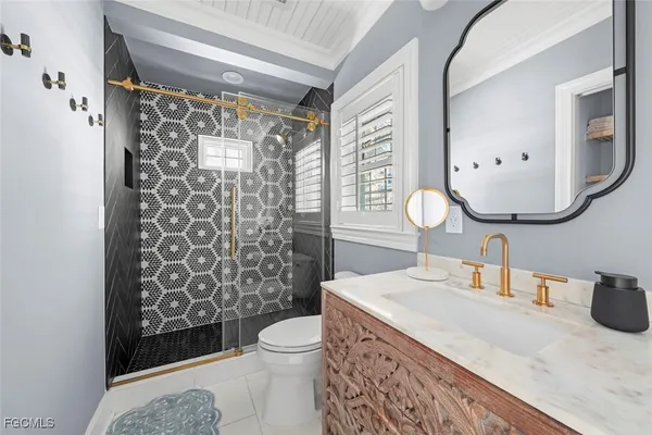 a bathroom with a sink a toilet and shower curtain