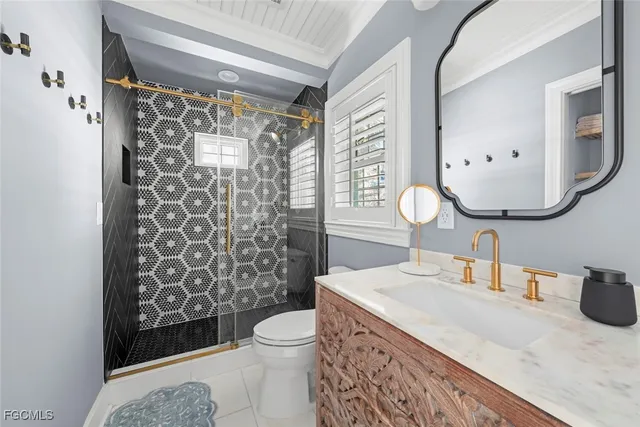 a bathroom with a sink a toilet and shower curtain