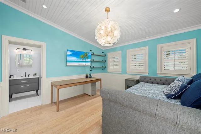 a bedroom with furniture and a large window