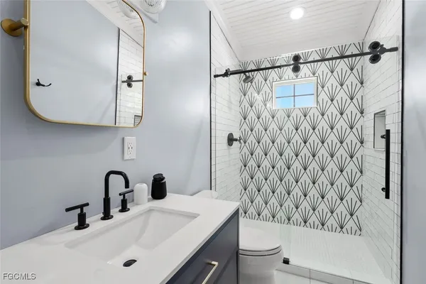 a bathroom with a sink toilet and shower