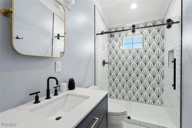 a bathroom with a sink toilet and shower