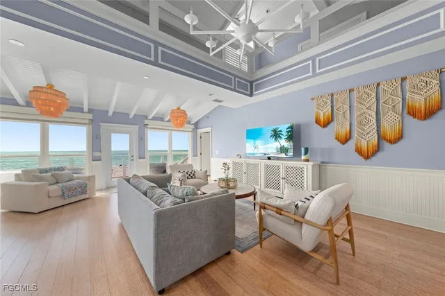 a living room with furniture and a chandelier