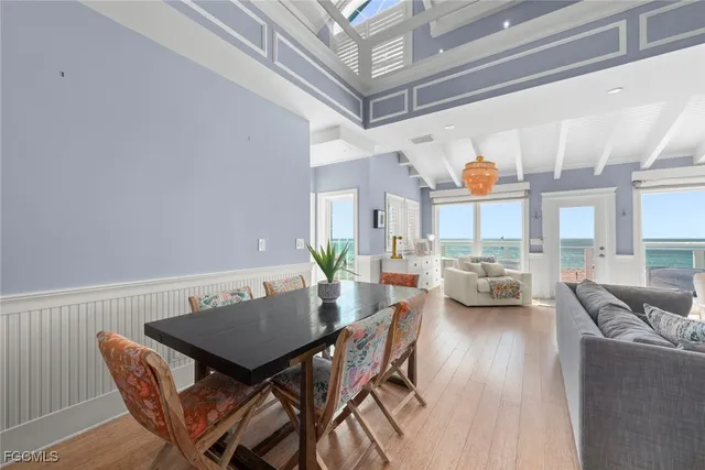 a view of a dining room with furniture and a potted plant