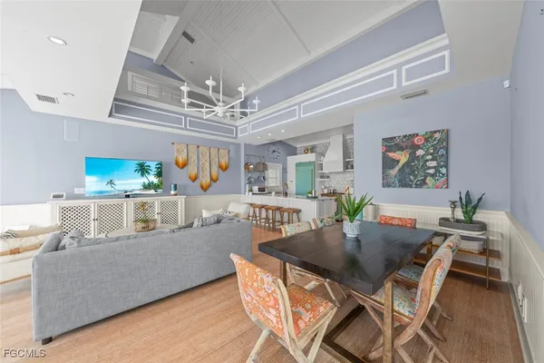 a dining room with furniture a rug and wooden floor