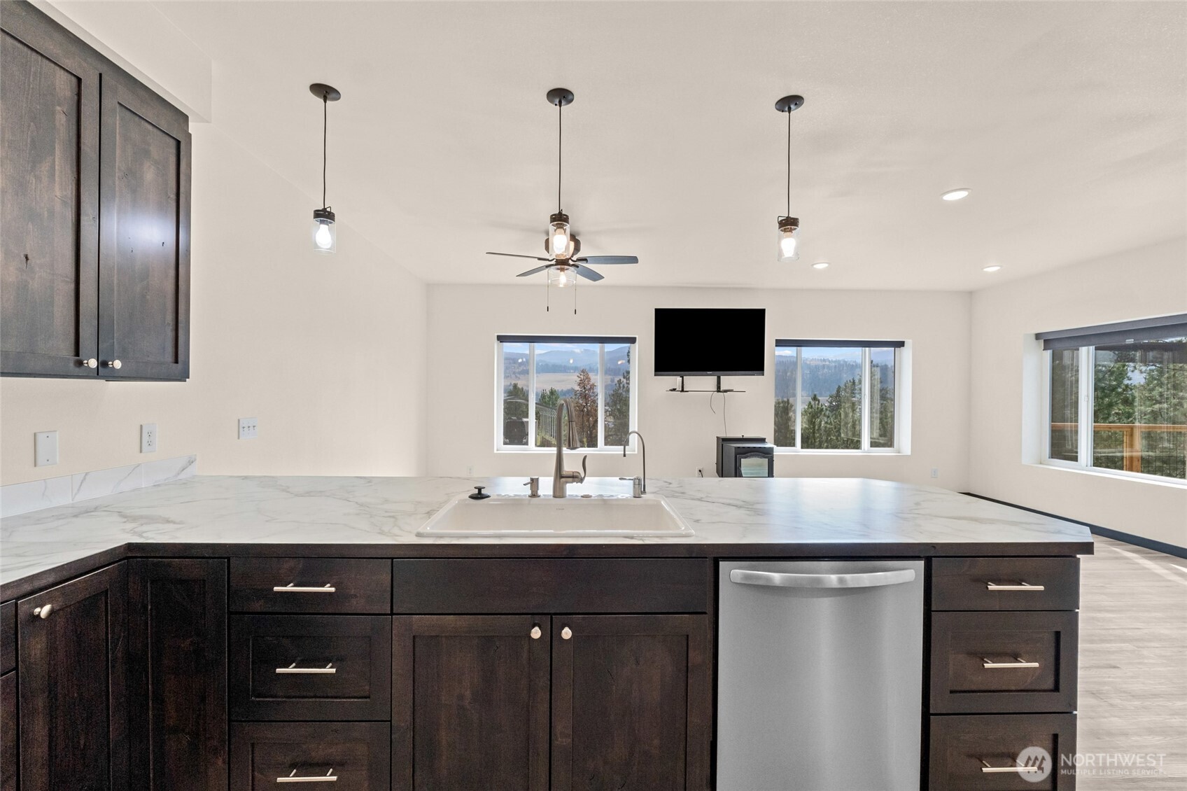 15 Miyoko Point Road Republic, WA 99166 - Photo 11 of 38 a kitchen with stainless steel appliances kitchen island granite countertop a sink and a granite counter tops