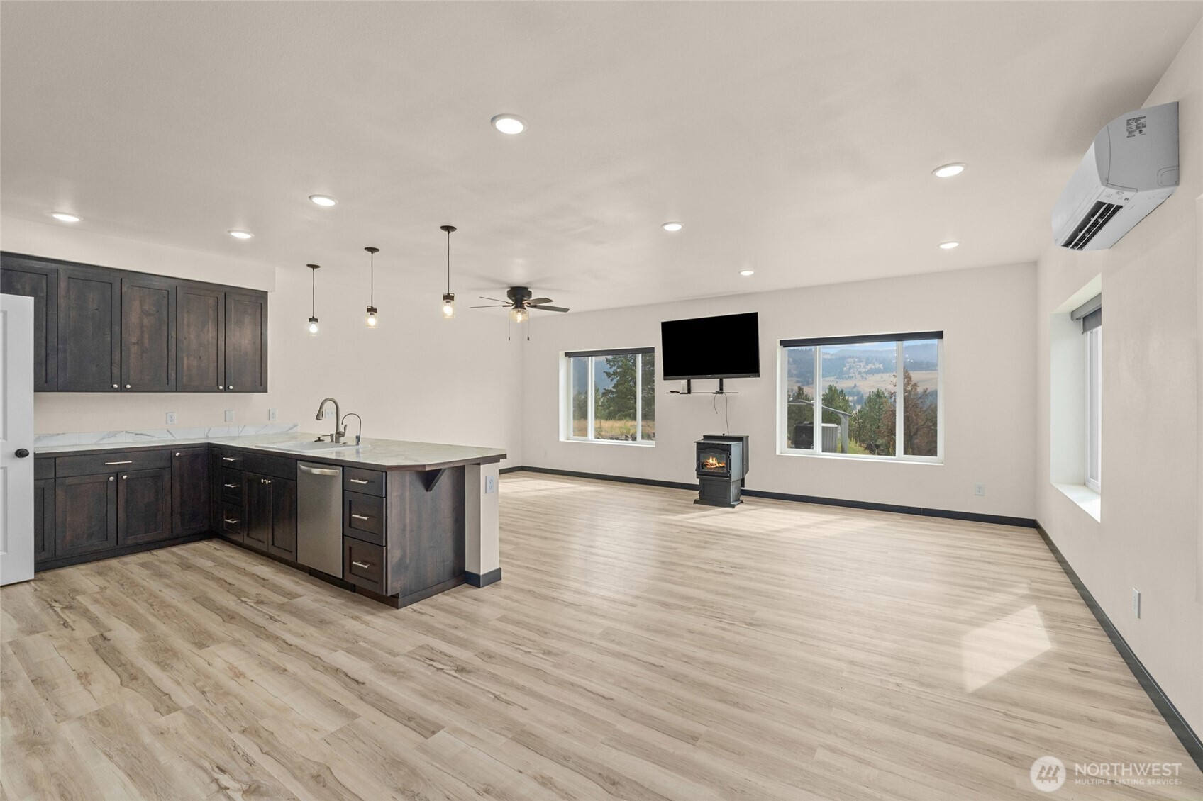 15 Miyoko Point Road Republic, WA 99166 - Photo 7 of 38 a large white kitchen with stainless steel appliances granite countertop a large counter top and a wooden floors