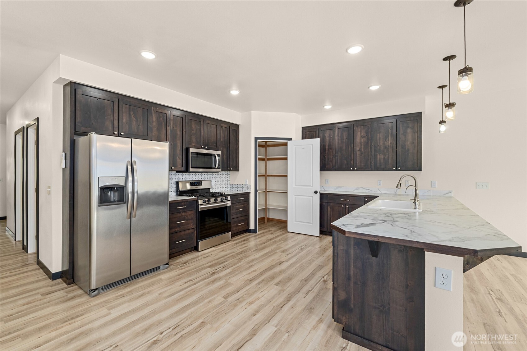 15 Miyoko Point Road Republic, WA 99166 - Photo 8 of 38 a kitchen with kitchen island a counter top space stainless steel appliances and cabinets