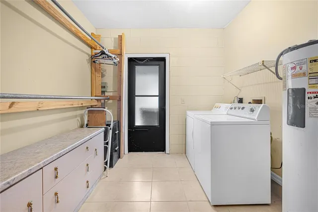 a utility room with cabinets washer and dryer