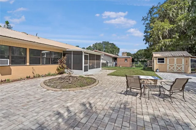 a view of a house with backyard and sitting area