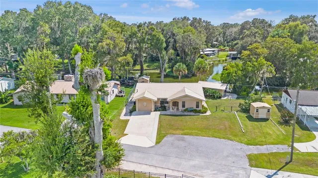 an aerial view of a house with swimming pool garden and mountain view