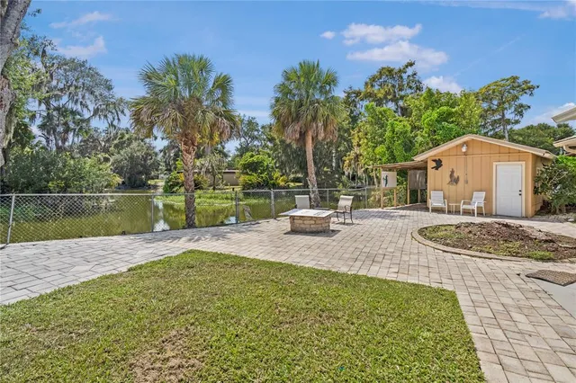 a view of a house with a yard and sitting area