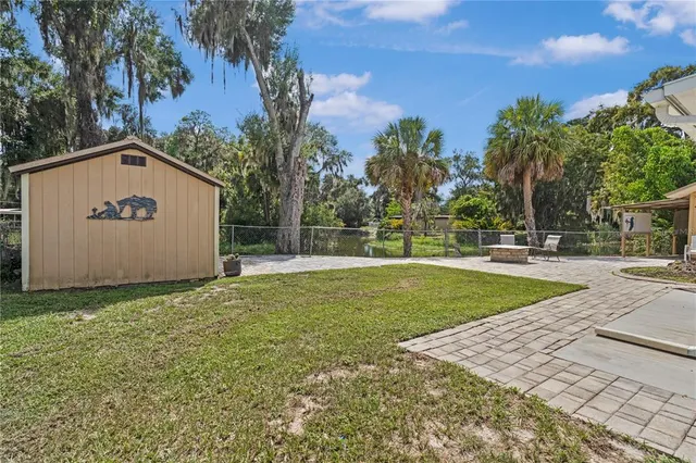 a view of a house with a yard and potted plants