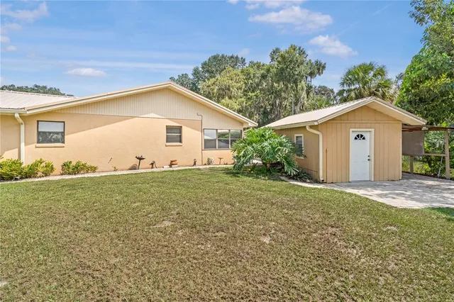 an aerial view of a house with outdoor space pool seating area and yard