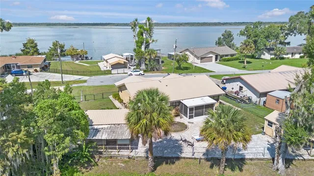 an aerial view of a house with swimming pool and outdoor seating