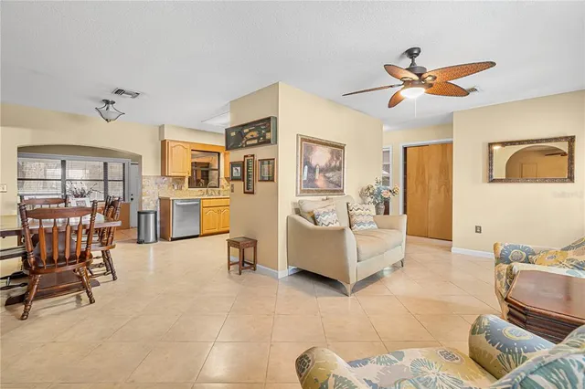 a living room with furniture and a dining table with projector the view
