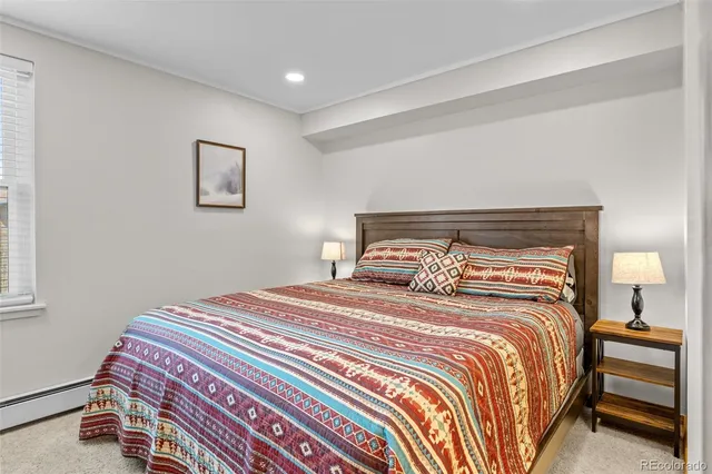 a bedroom with a bed and a lamp