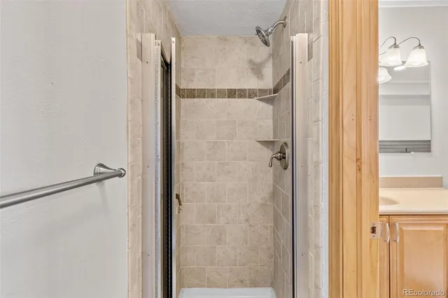 a bathroom with a glass shower door