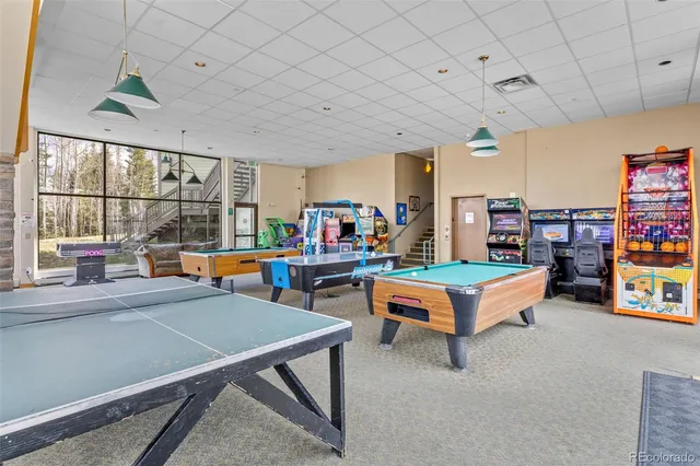 a living room with lots of furniture and a chandelier