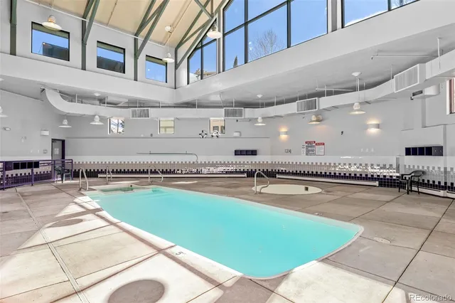 a swimming pool with outdoor seating and yard