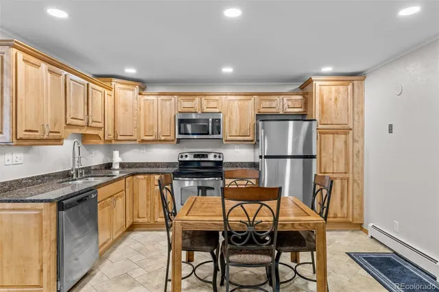 a kitchen with kitchen island granite countertop wooden cabinets and stainless steel appliances