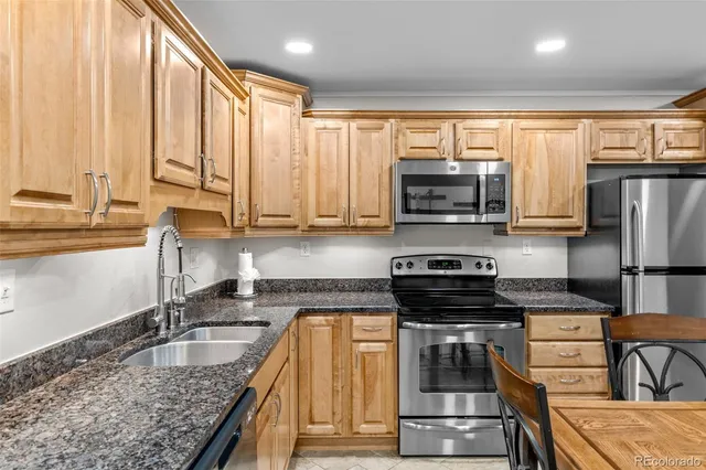 a kitchen with a stove a sink and a microwave