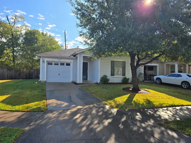 a view of a house with swimming pool and a yard