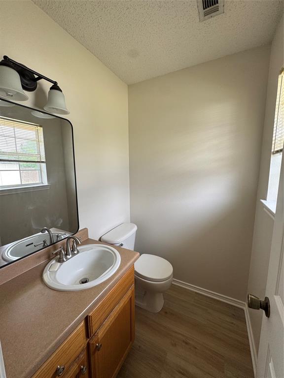 1109 North Riggins Street Anna, TX 75409 - Photo 6 of 11 a bathroom with a sink toilet and mirror