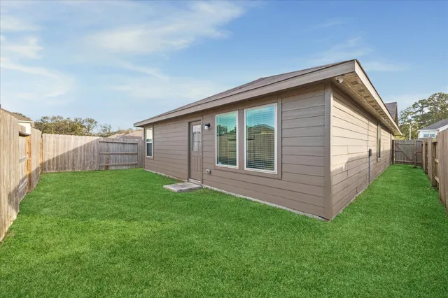 a view of a backyard with plants and a garden
