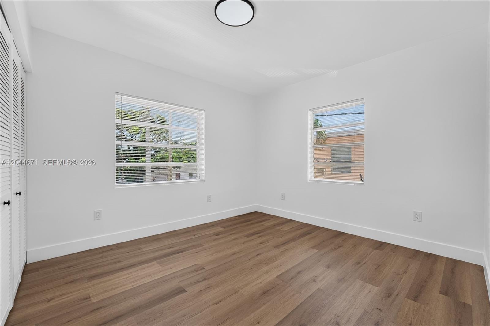 1900 Southwest 6th Street, Unit 6 Miami, FL 33135 - Photo 16 of 20 an empty room with wooden floor and windows