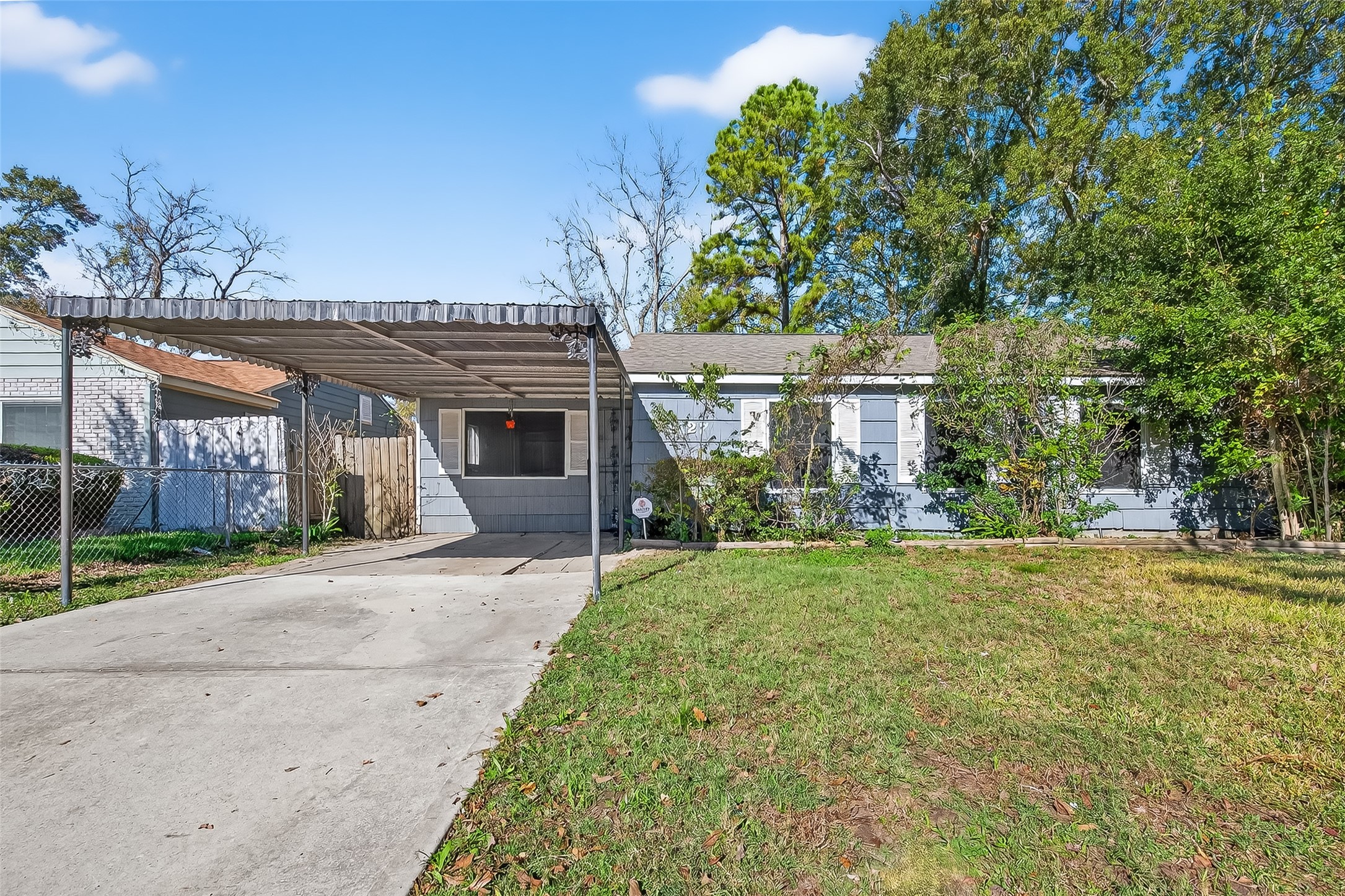 front view of a house with a yard and an trees