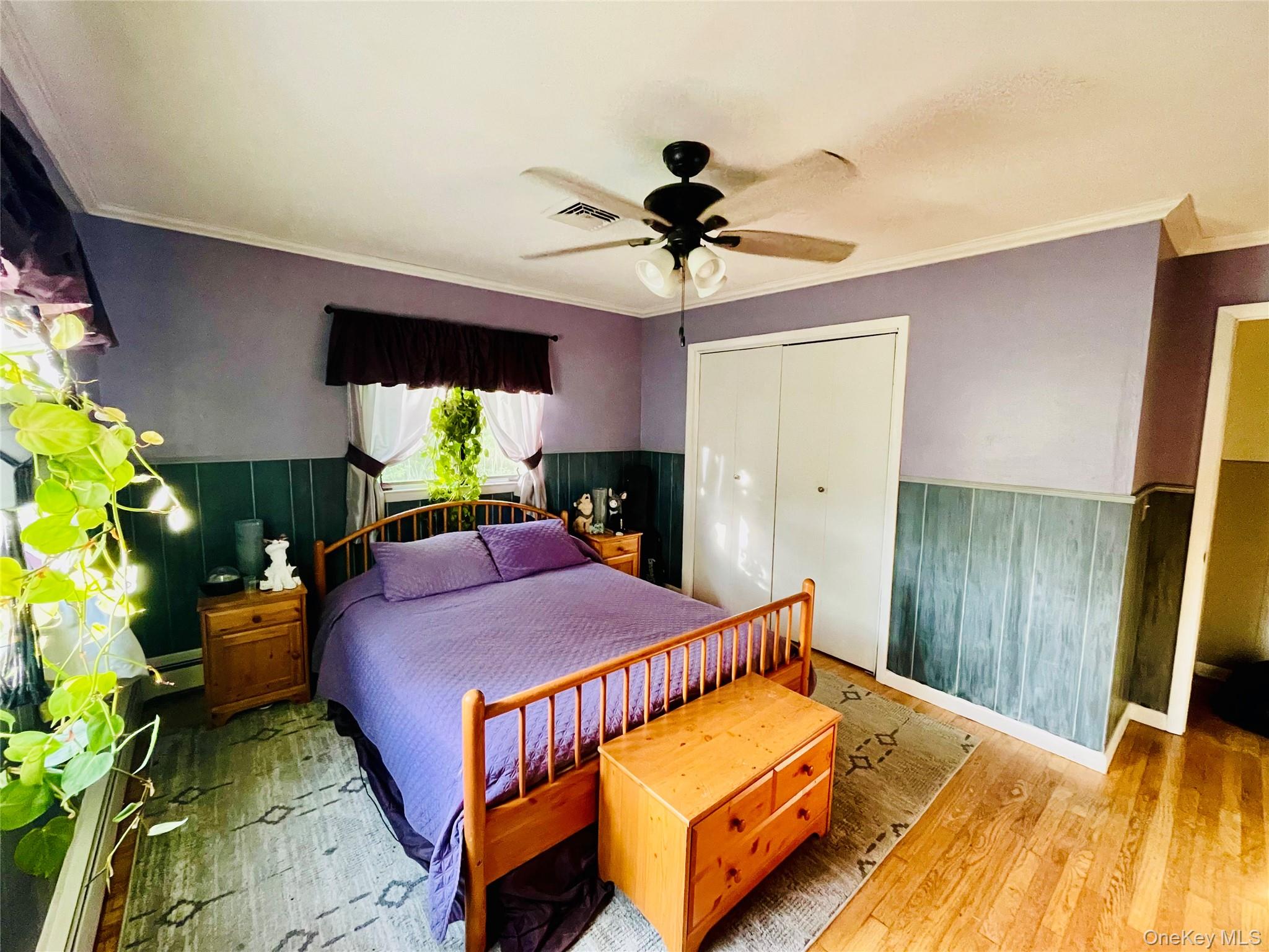137 Cross Road Goshen, NY 10924 - Photo 15 of 50 a bed room with a bed mirror and a chandelier