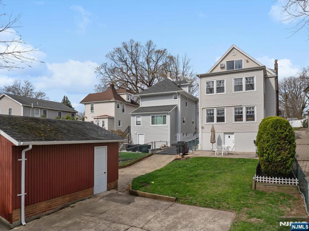 119 Overpeck Avenue Ridgefield Park, NJ 07660 - Photo 33 of 44 a front view of a house with a yard
