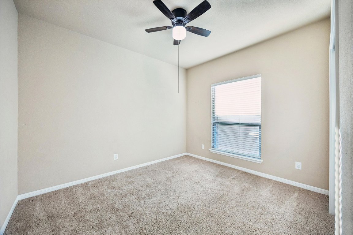 7517 Hickman Street Temple, TX 76502 - Photo 13 of 16 an empty room with a window and a ceiling fan