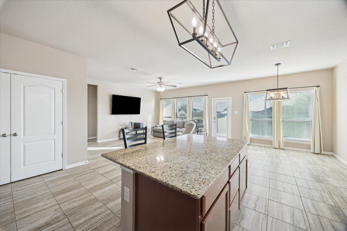 7517 Hickman Street Temple, TX 76502 - Photo 4 of 16 a kitchen with stainless steel appliances granite countertop a sink a microwave counter space and cabinets