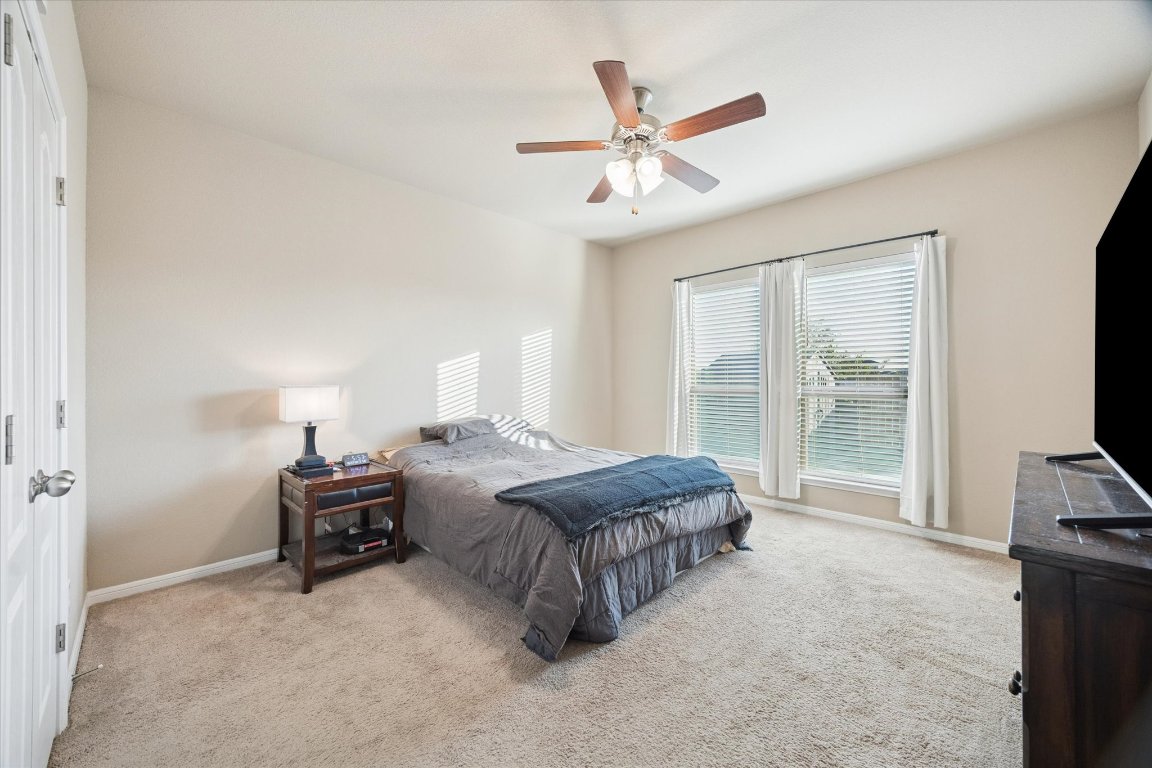 7517 Hickman Street Temple, TX 76502 - Photo 7 of 16 a spacious bedroom with a bed and a flat tv screen on the dresser