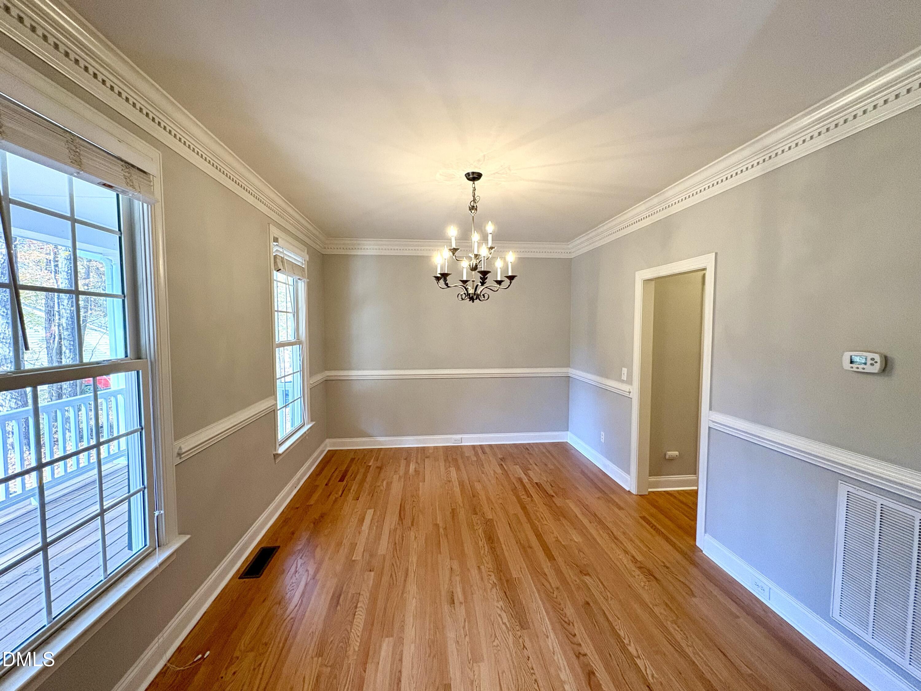 3304 Drexel Hill Court Apex, NC 27539 - Photo 3 of 20 wooden floor in an empty room with a window