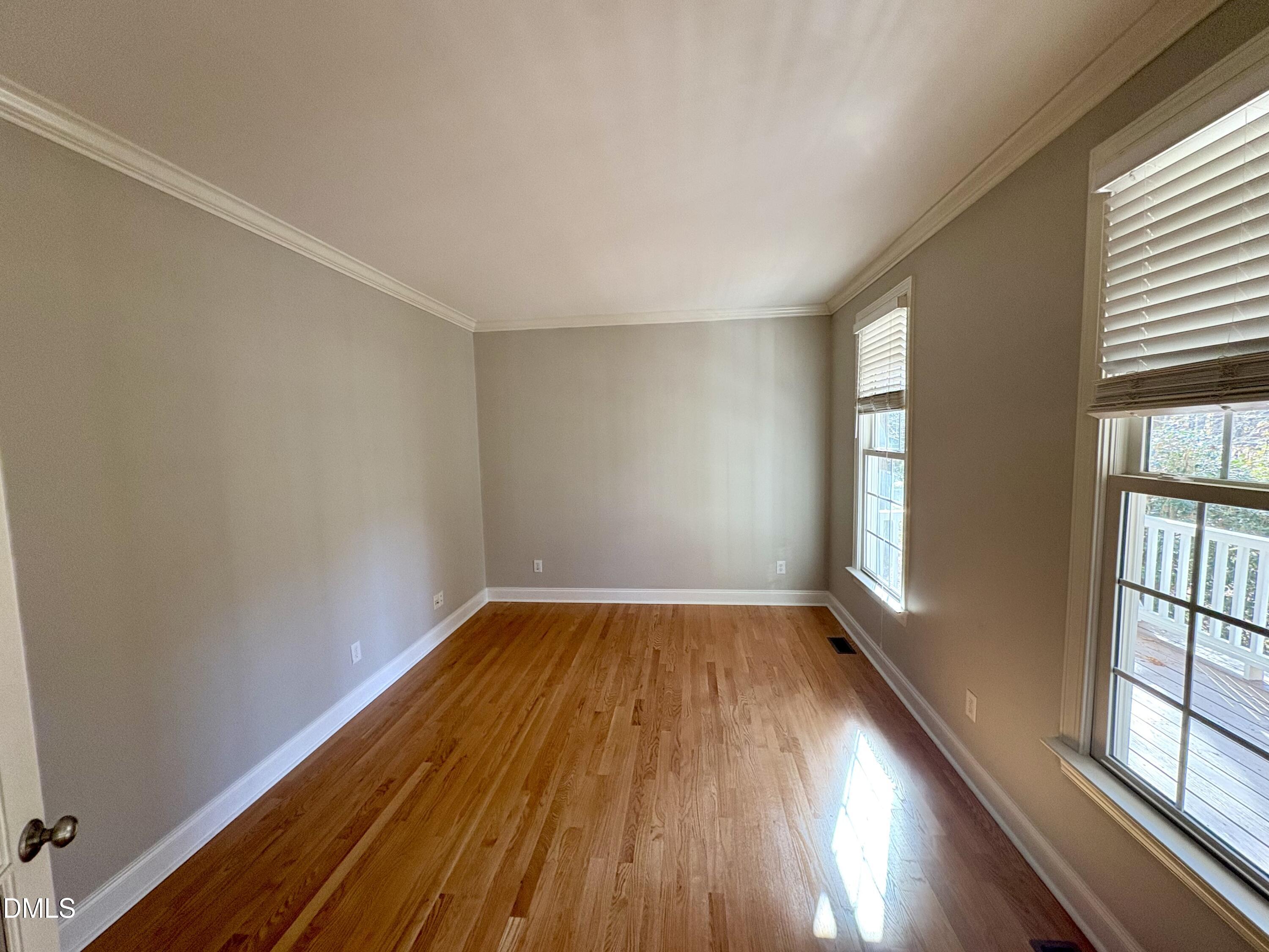 3304 Drexel Hill Court Apex, NC 27539 - Photo 4 of 20 wooden floor in an empty room with a window