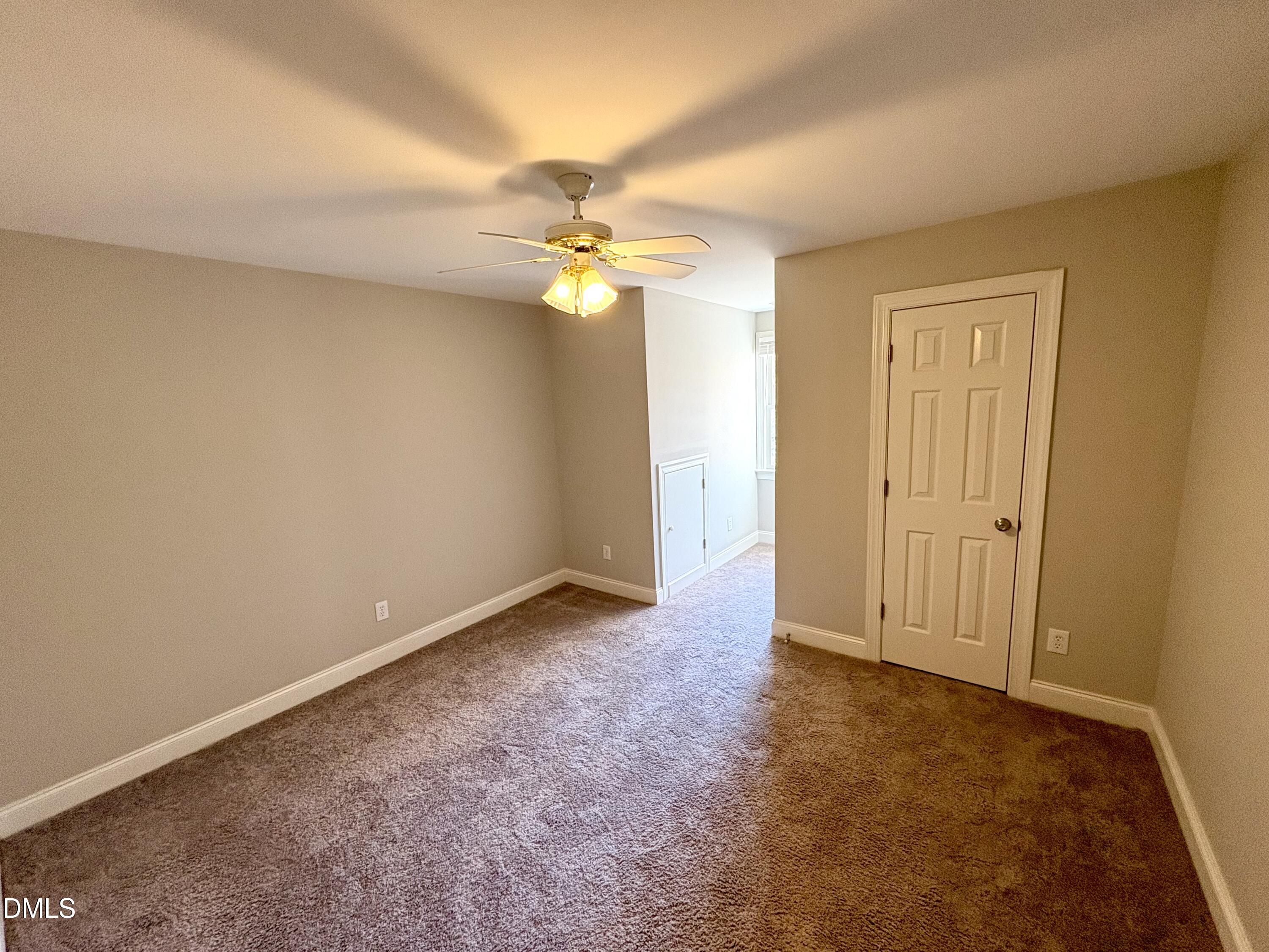 3304 Drexel Hill Court Apex, NC 27539 - Photo 8 of 20 an empty room with a fan and a chandelier fan